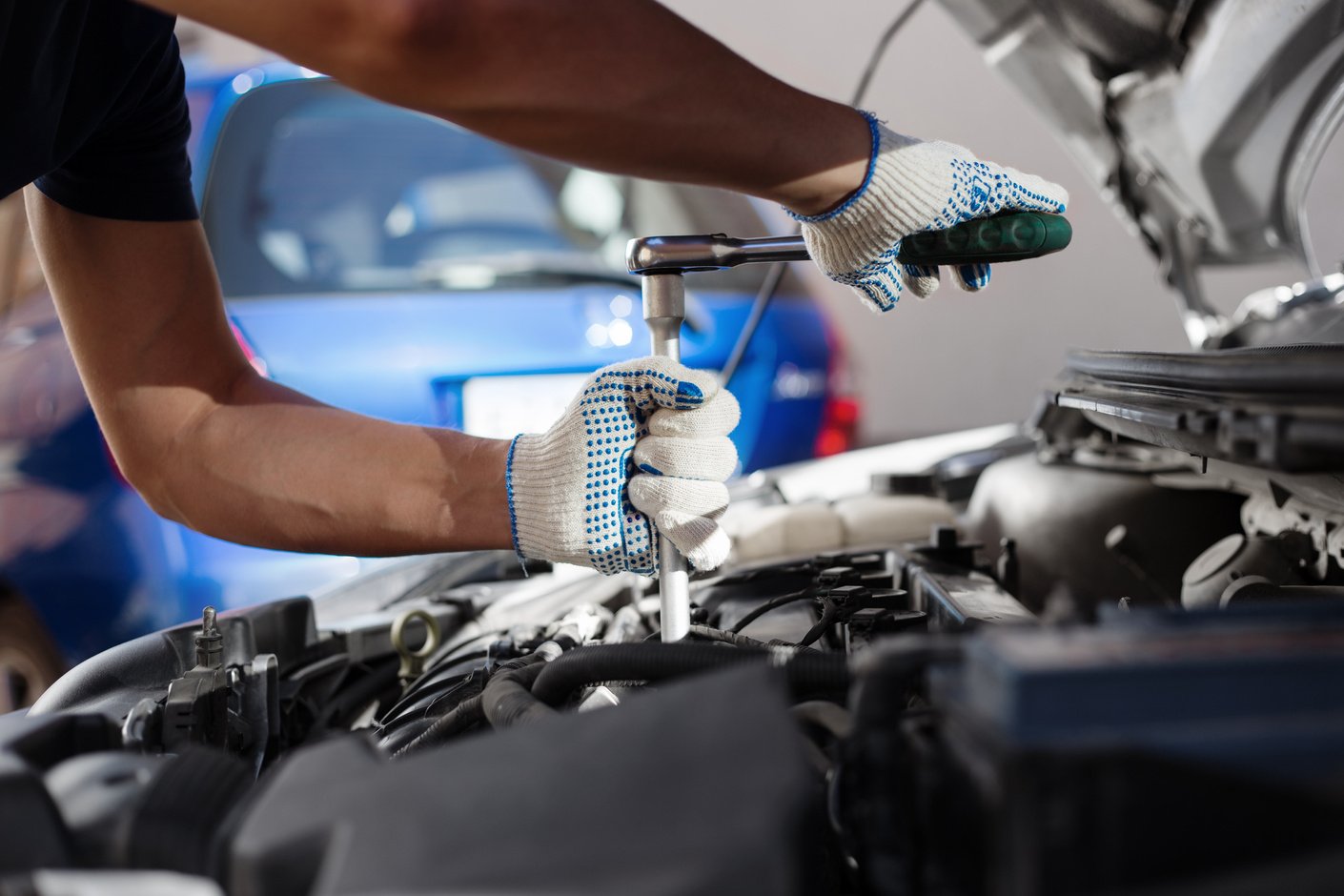 Mechanic working in auto repair garage. Car maintenance
